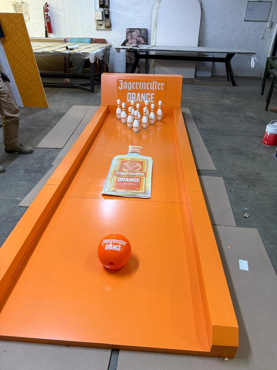 A reupholstered Victorian-style loveseat in orange velvet, trimmed with neon-orange LED edge lighting